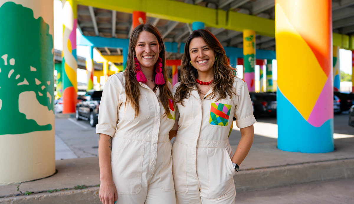 artists in front of public artwork